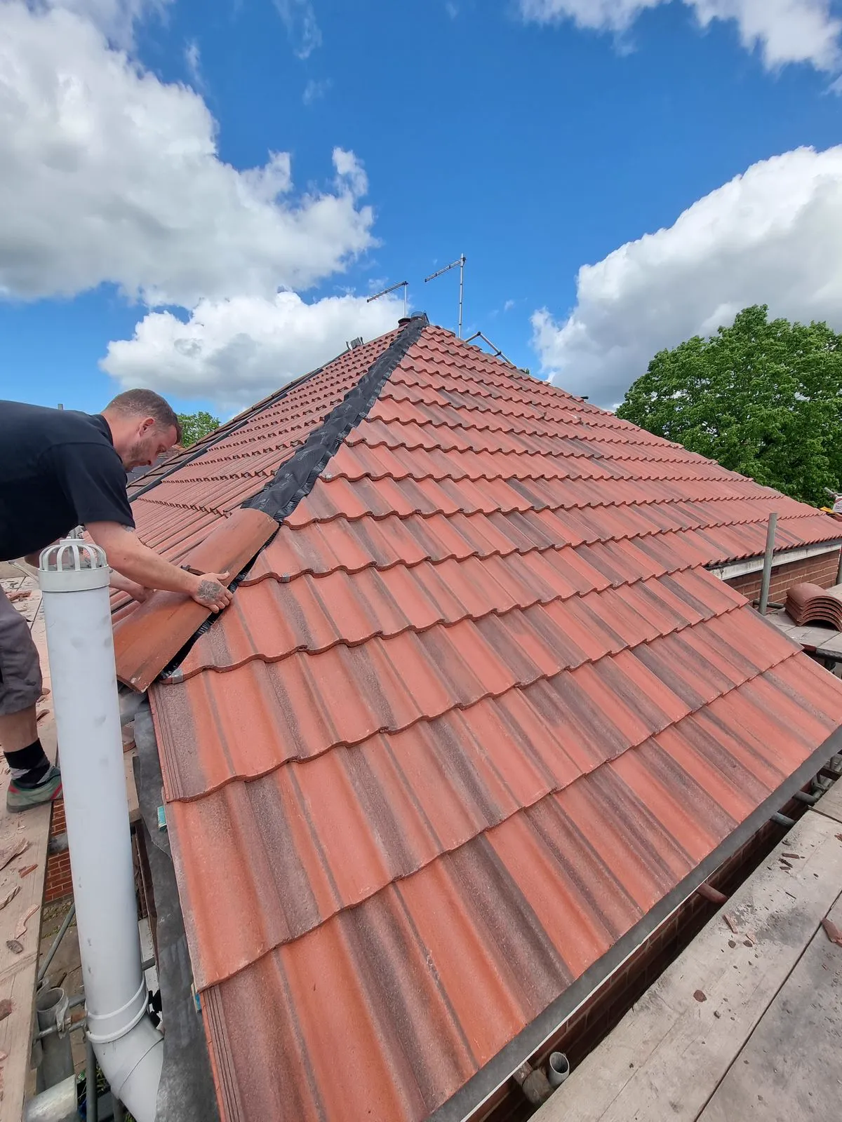 Newly laid red clay tile roof against a blue sky