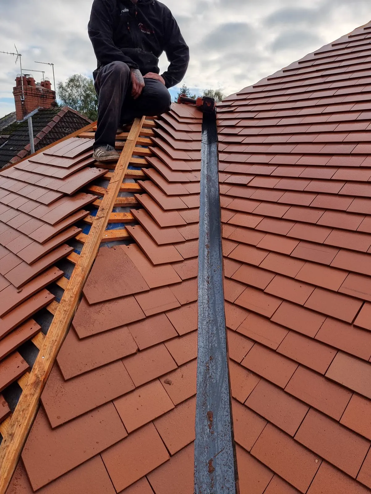 Close-up of new tile courses and ridge line workmanship